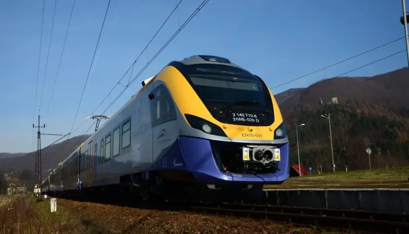 Nowoczesny pociąg EN78-001 na torach. Czy do Krynicy Zdrój można dojechać pociągiem? Tak, ta linia kolejowa prowadzi do malowniczych miejscowości.