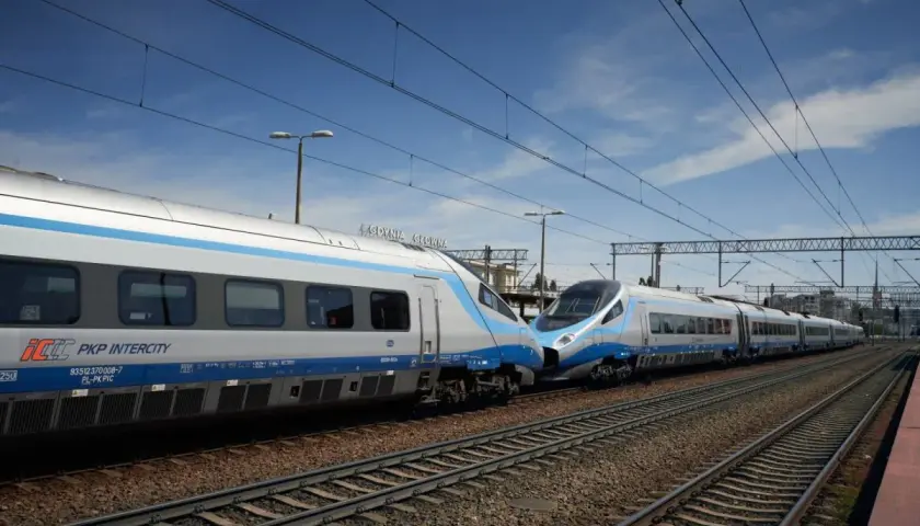 Dwa pociągi Pendolino PKP Intercity stoją obok siebie na torach.