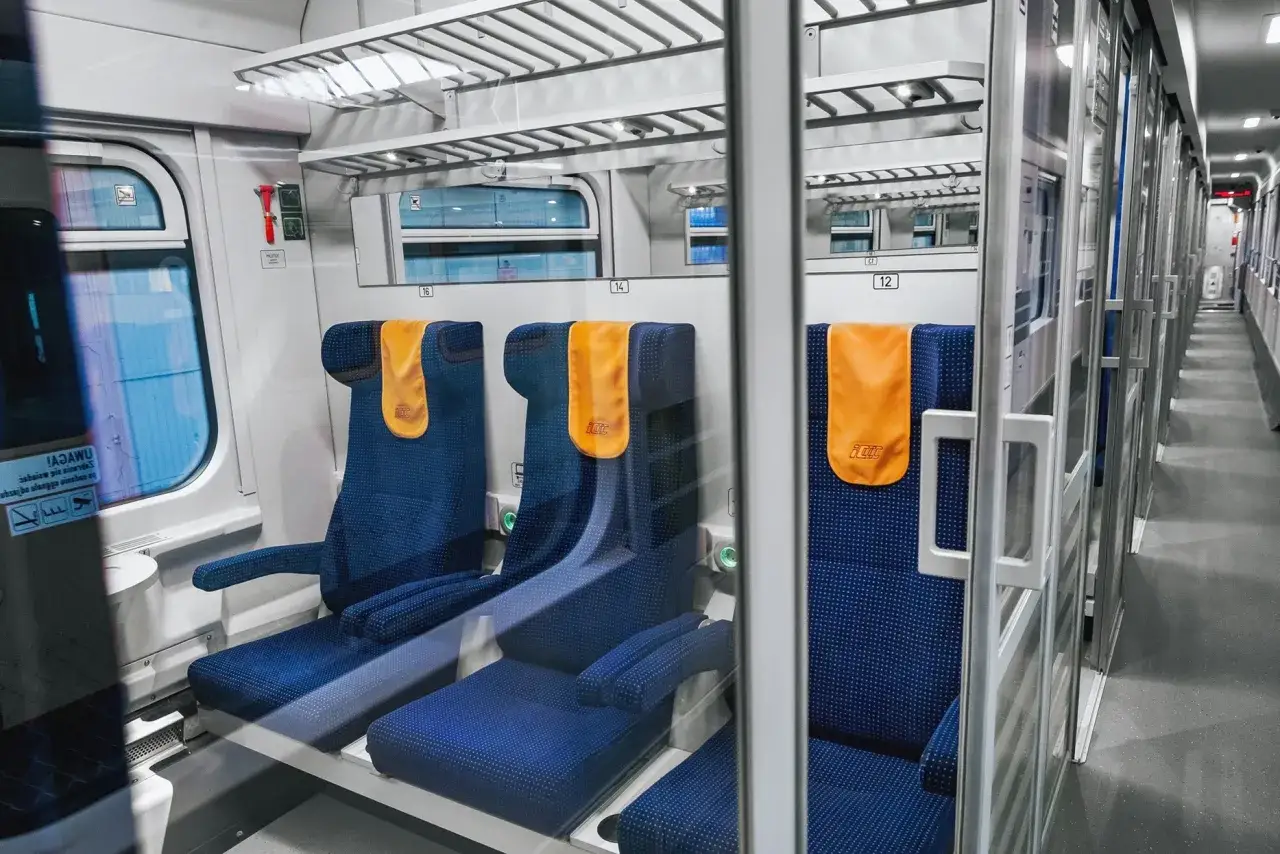 Wygodne siedzenia w wagonie Intercity, gotowe na podróż. Co to znaczy intercity? To komfort i szybkość podróżowania po Polsce.